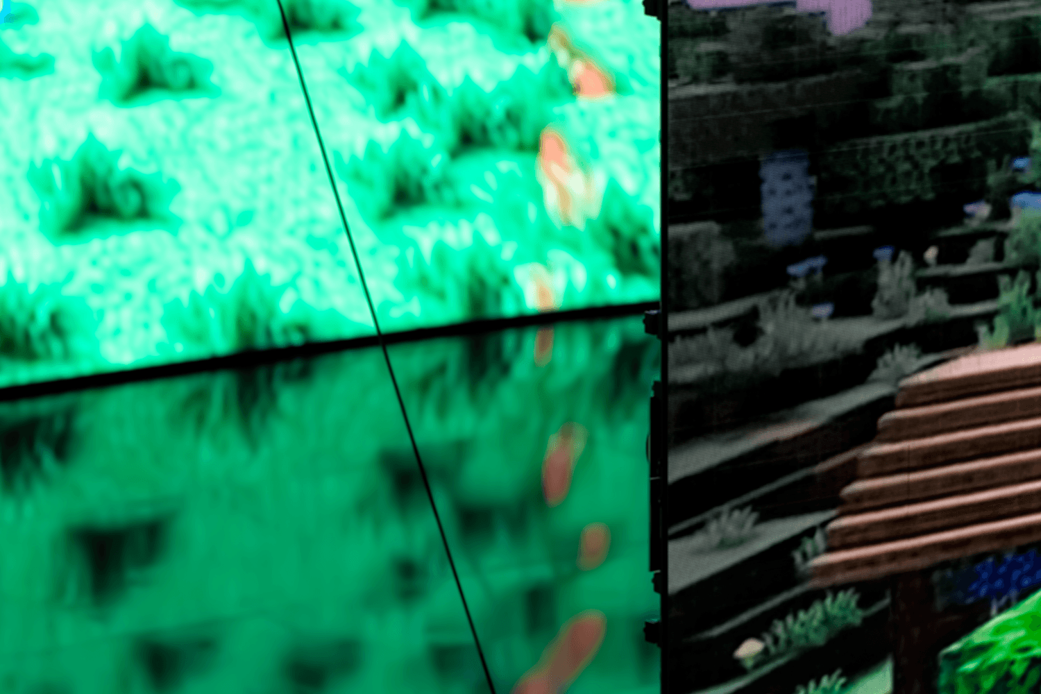 Close-up of green geometric patterned screens flanking the stage