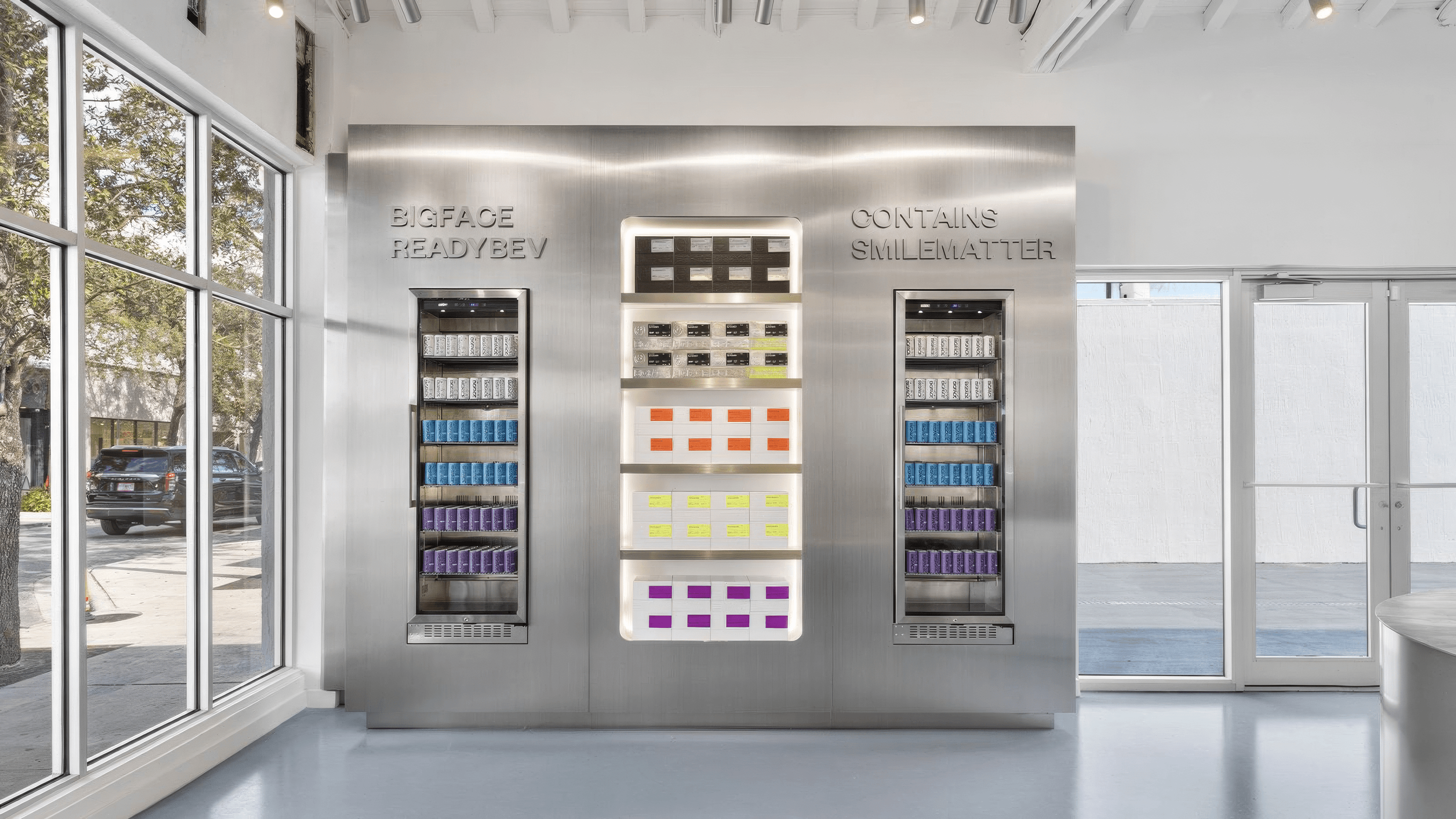 Illuminated stainless steel wall display case holding rows of skincare and grooming products