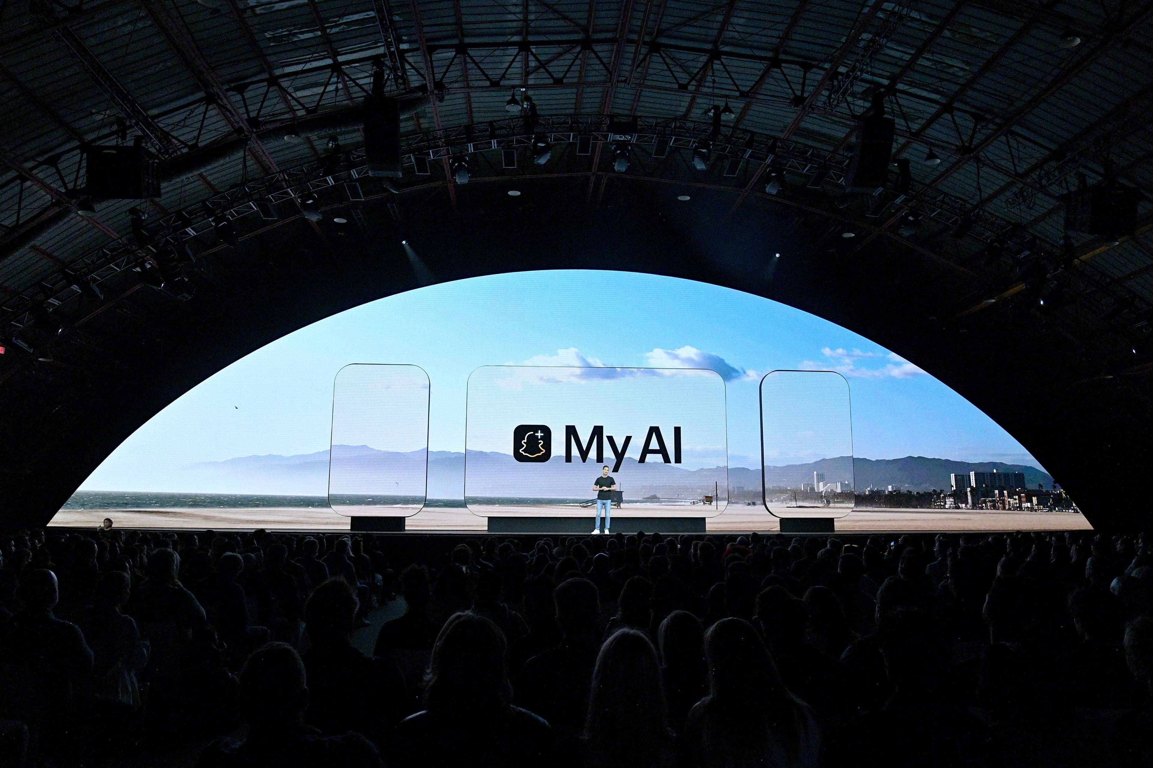 Arched tent interior with a large screen reading 'My AI' above an empty stage.