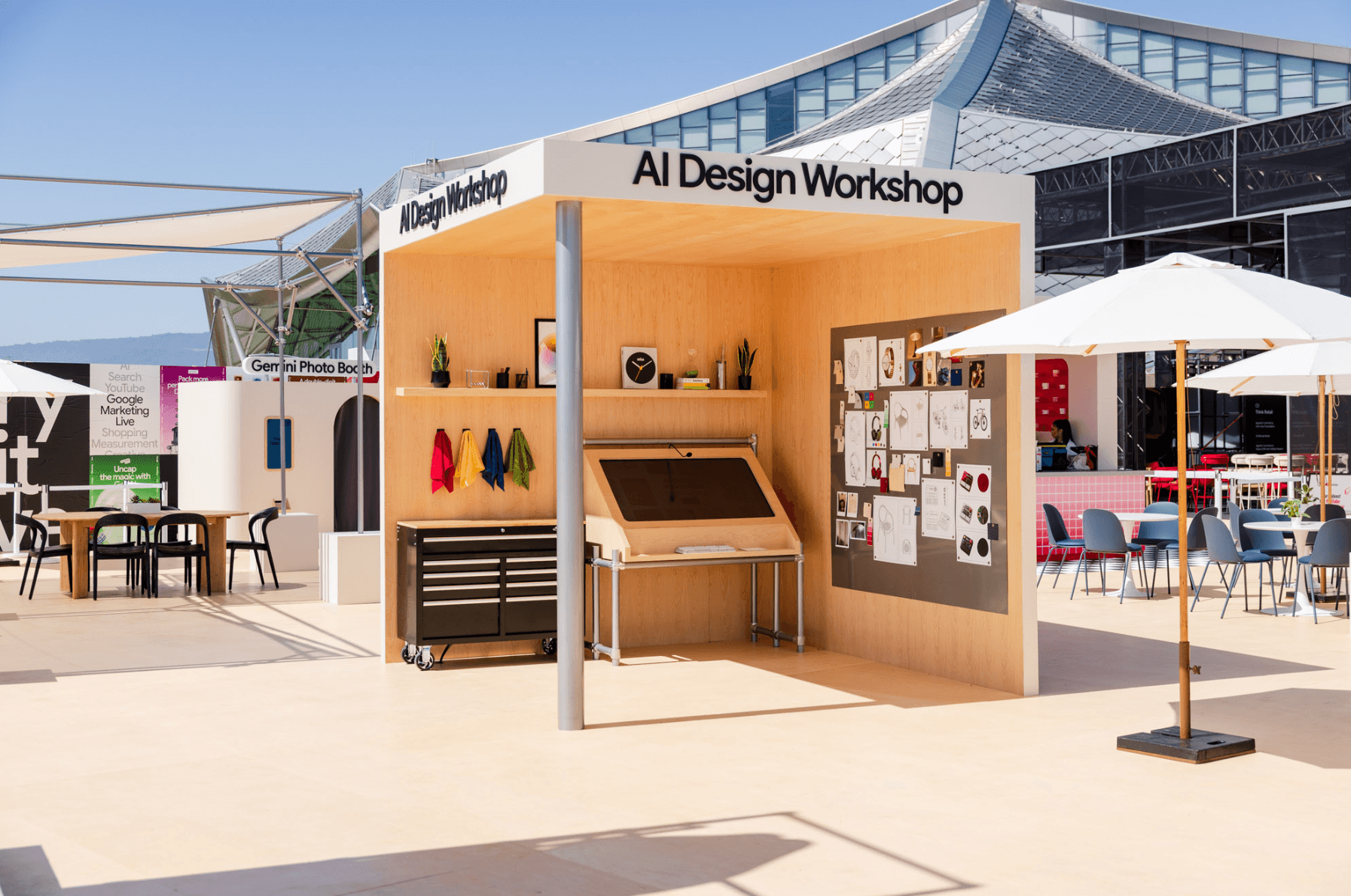 Wooden pavilion booth labeled "AI Design Workshop" with shelving, potted plants, and outdoor lounge seating.
