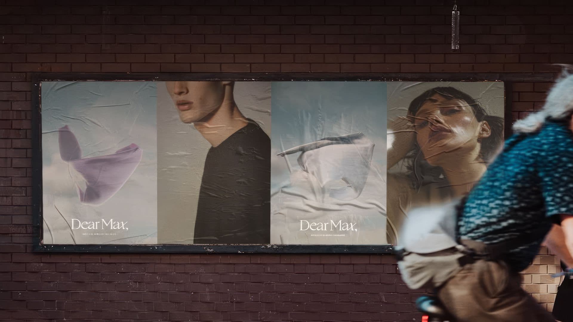 Row of four Dear Max street posters on a brick wall showing abstract fabric, a portrait, and a model with a scarf, partly obscured by a passerby.