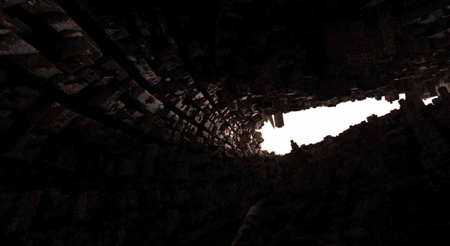 Dark tunnel of folded city buildings converging toward a bright opening in the distance.