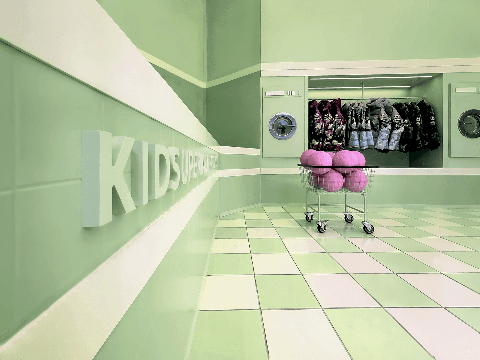 Store interior in perspective view with a large KIDSUPER wordmark on the wall and a cart of folded clothing