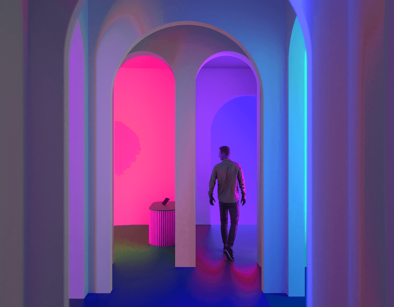 A person walks through a series of arched doorways lit in pink, purple, and blue, with a small round table in one alcove.
