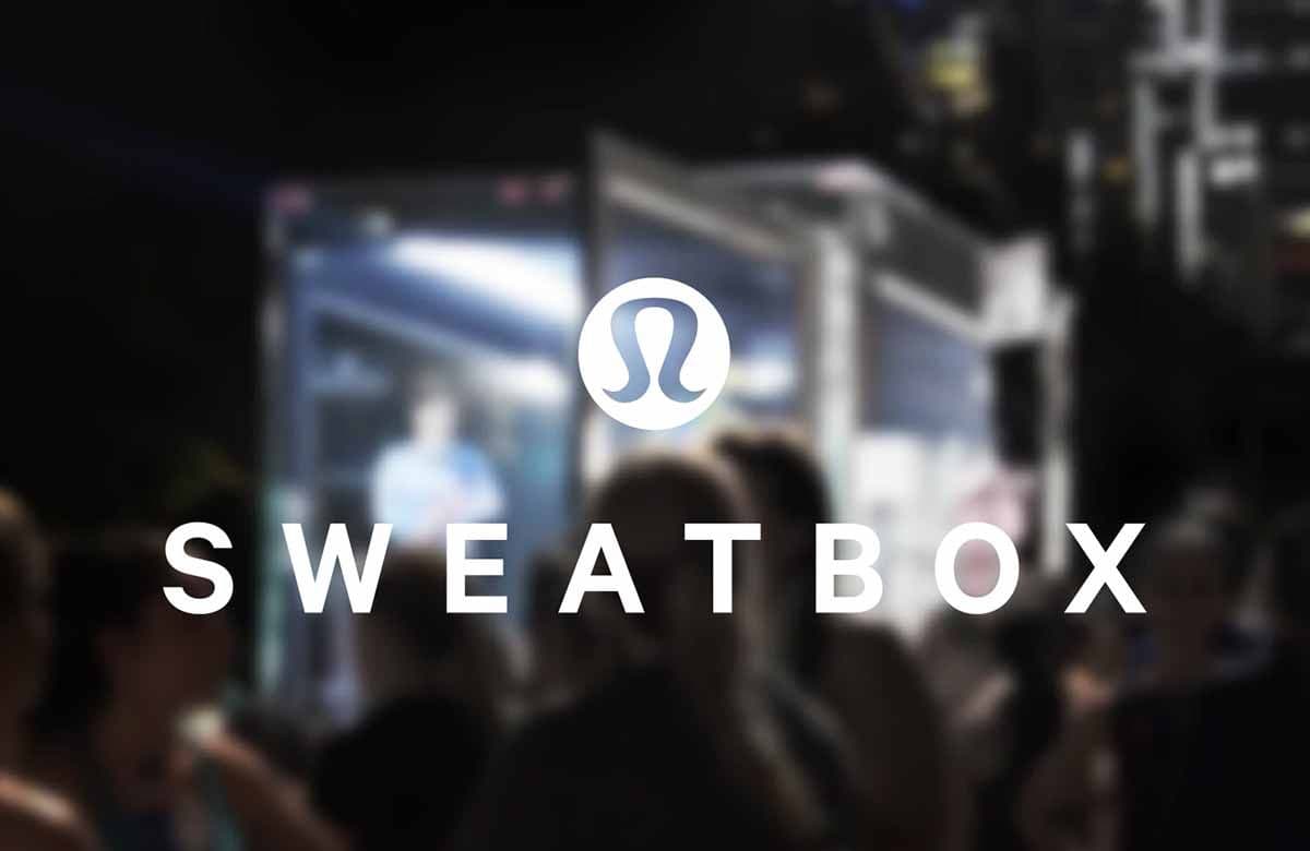 Illuminated truck screen reading 'Sweatbox' with a crowd gathered at night