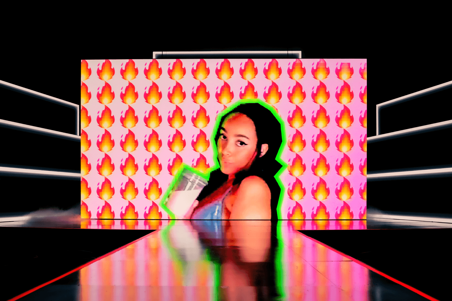 Stage screen displaying a magenta and orange geometric pattern beside a portrait of a performer