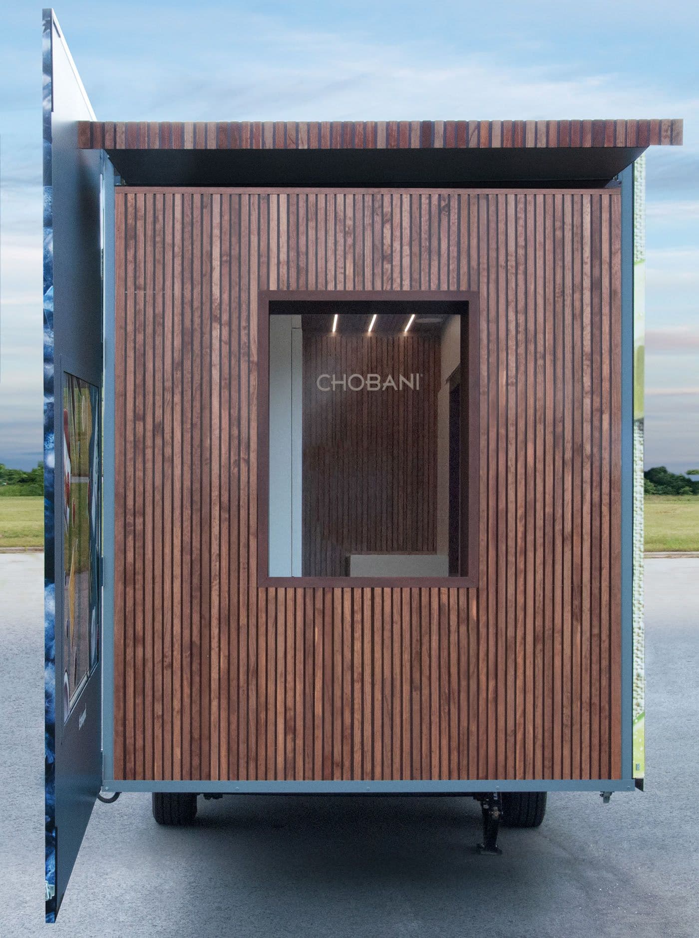 End view of the trailer showing a serving window beneath an angled wood-slat canopy.