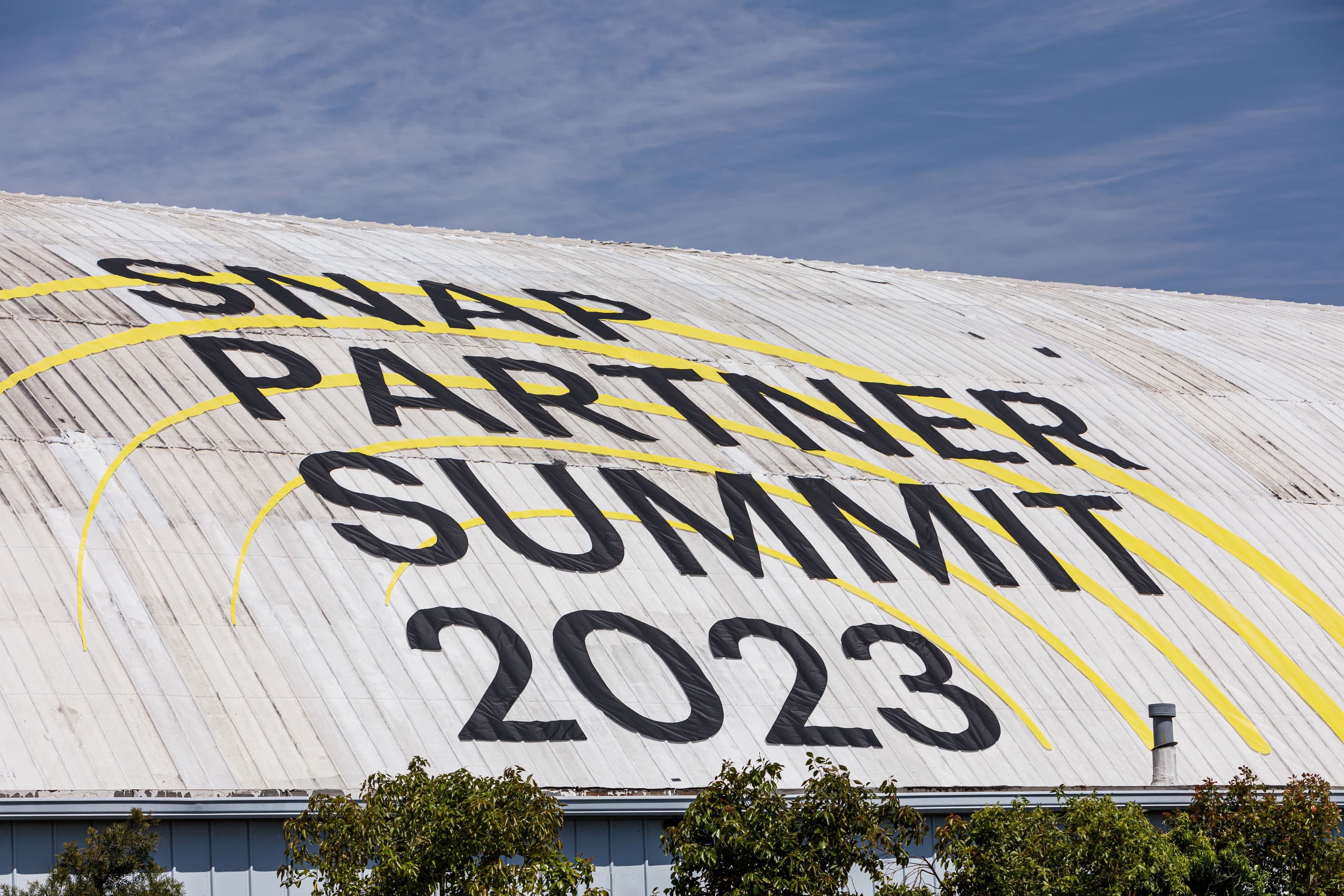 Large tent roof painted with the text 'Snap Partner Summit 2023' seen from above.