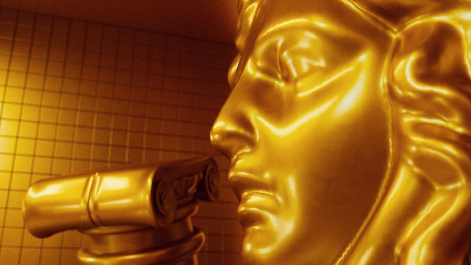 Close-up profile of the gold Medusa head sculpture.