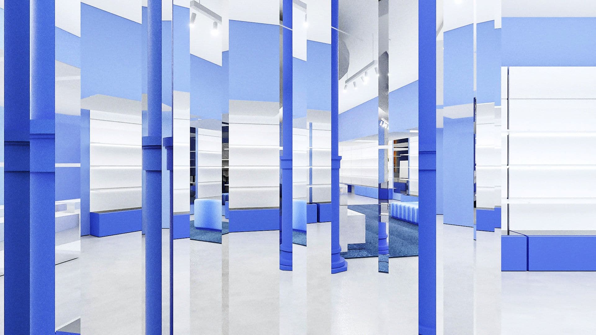 Empty retail floor lined with mirrored blue partition panels and a cobalt column, white shelving visible beyond.
