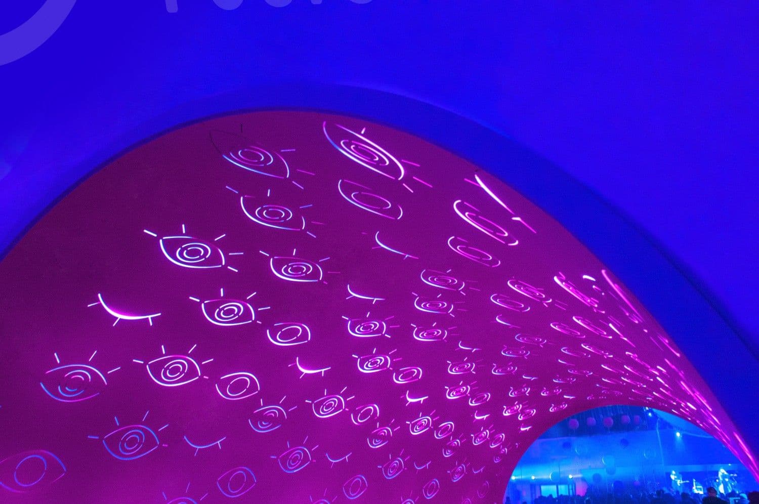 Purple curved dome ceiling densely covered in illustrated eye doodles.