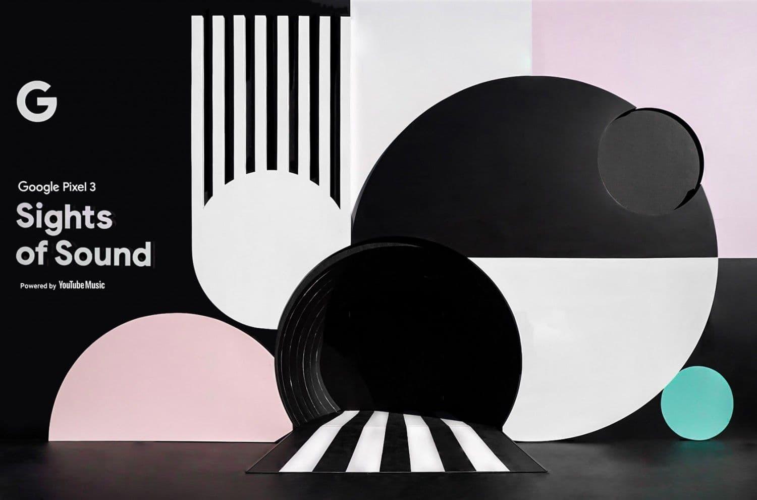 Black and white geometric booth with Google Pixel 3 "Sights of Sound" branding and pink and teal accents.