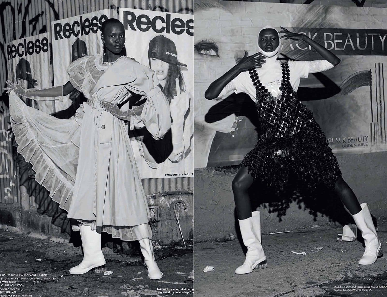 Black-and-white editorial diptych with caption text: a model in an oversized trench coat with sheer layered skirt poses arms outstretched in front of "Recless" posters, beside a model in a black beaded chainmail-style dress and white boots posing in front of a "Black Beauty" mural.