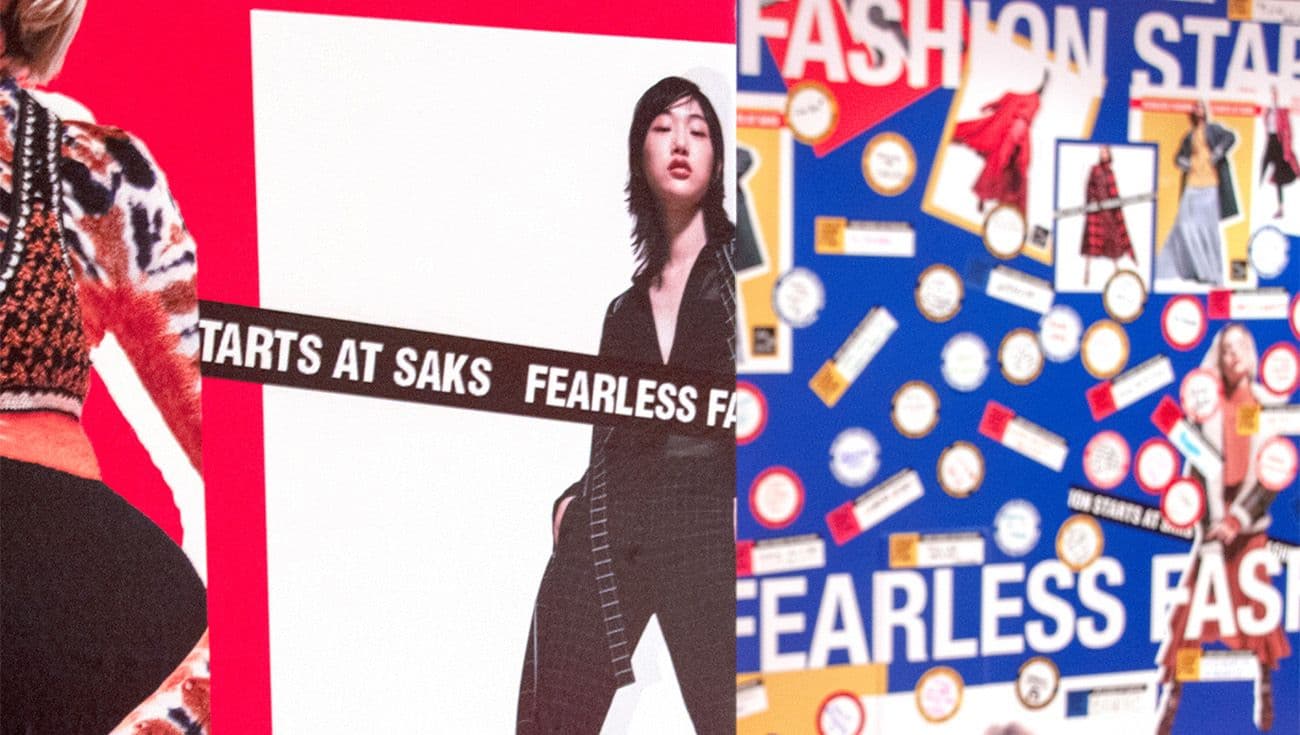 Detail of fashion campaign wall panels reading "Fearless Fashion" and "Starts At Saks" with model imagery.