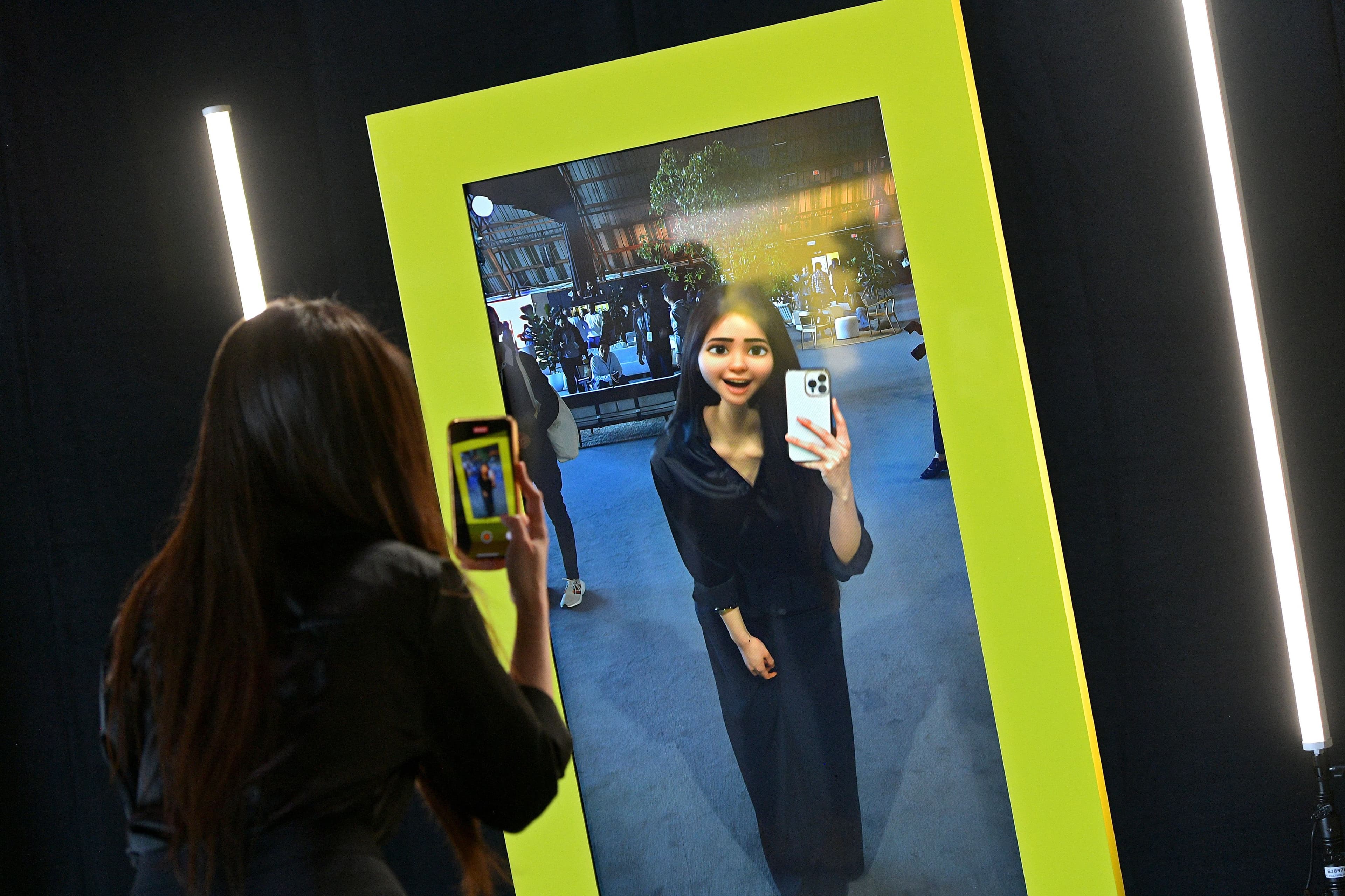 Two people taking a selfie in a mirror framed by a glowing yellow-green border.