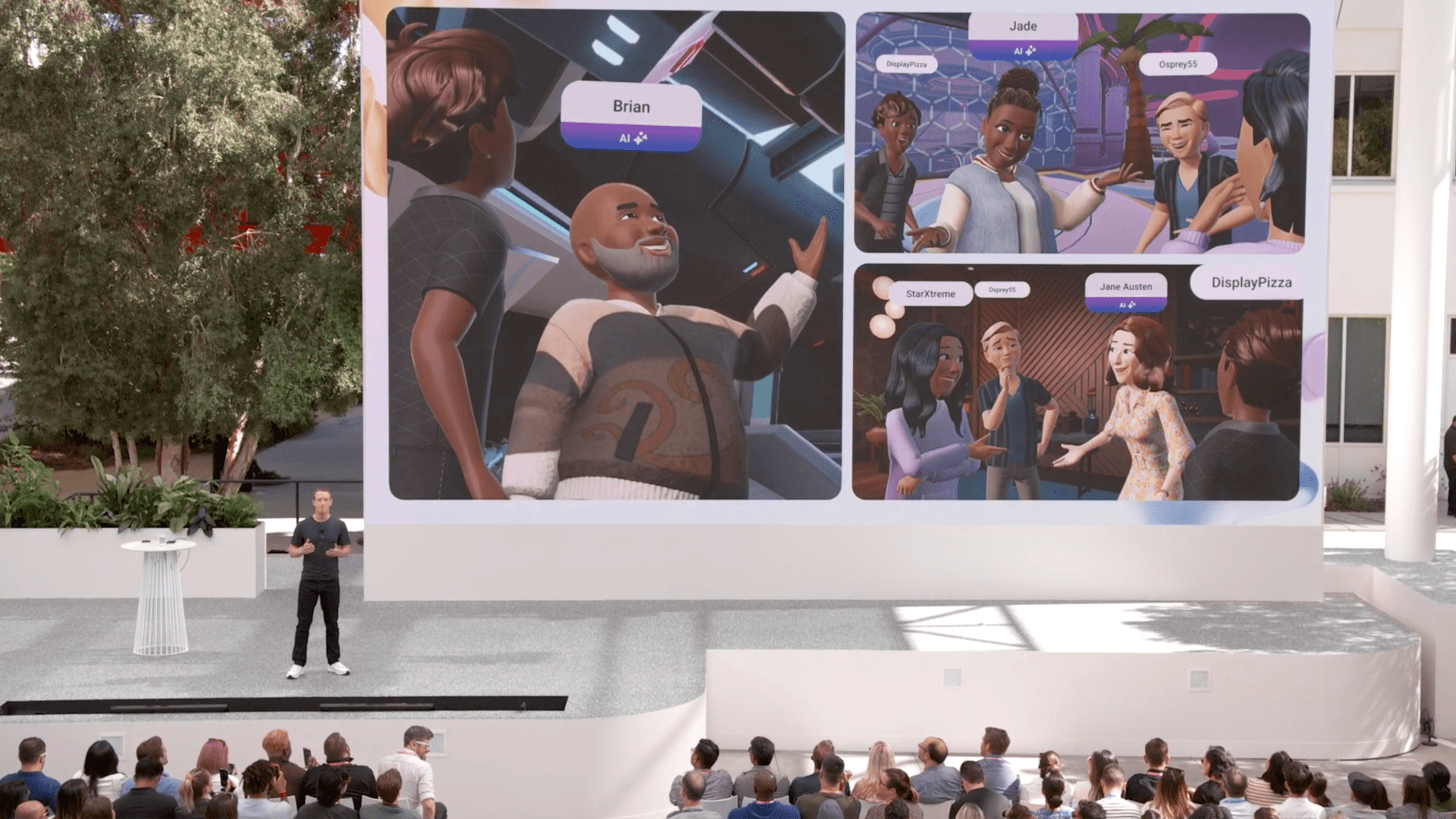 Presenter on stage in front of a screen displaying four illustrated avatar scenes.