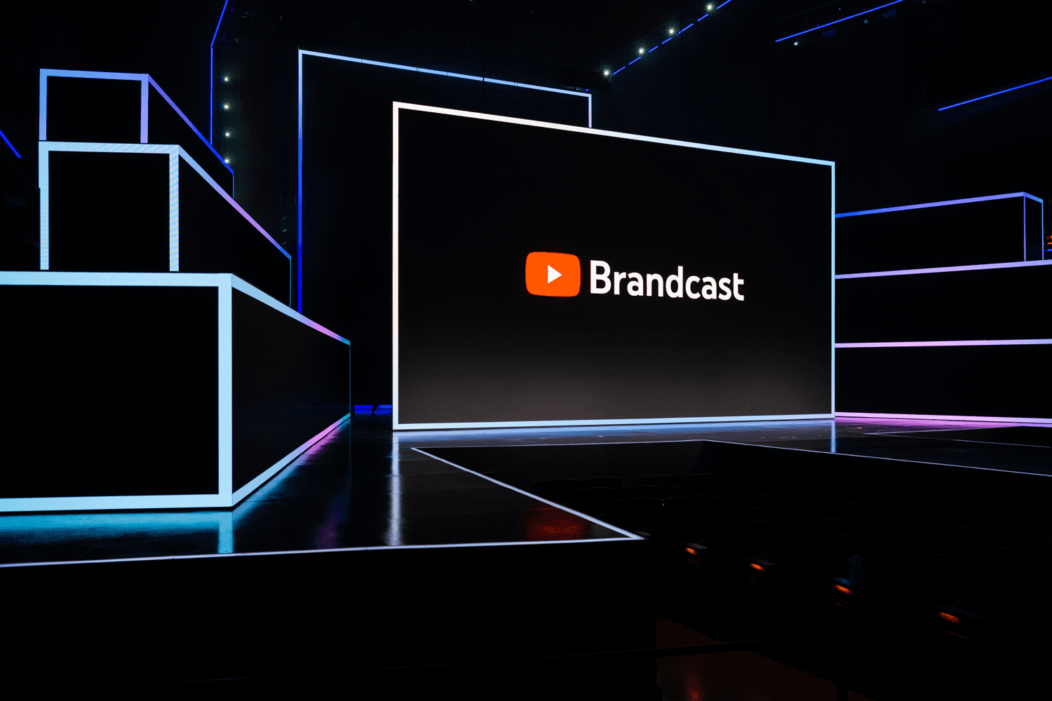 Stage screen reading "Brandcast" on an angular blue-lit set