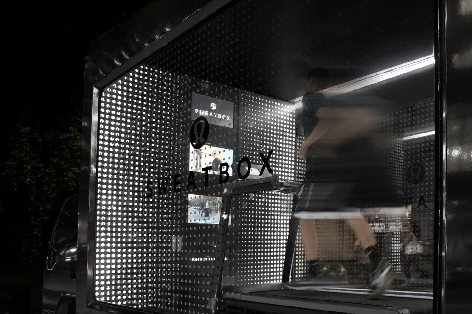 Close-up of the truck's open perforated metal door frame lit from inside at night
