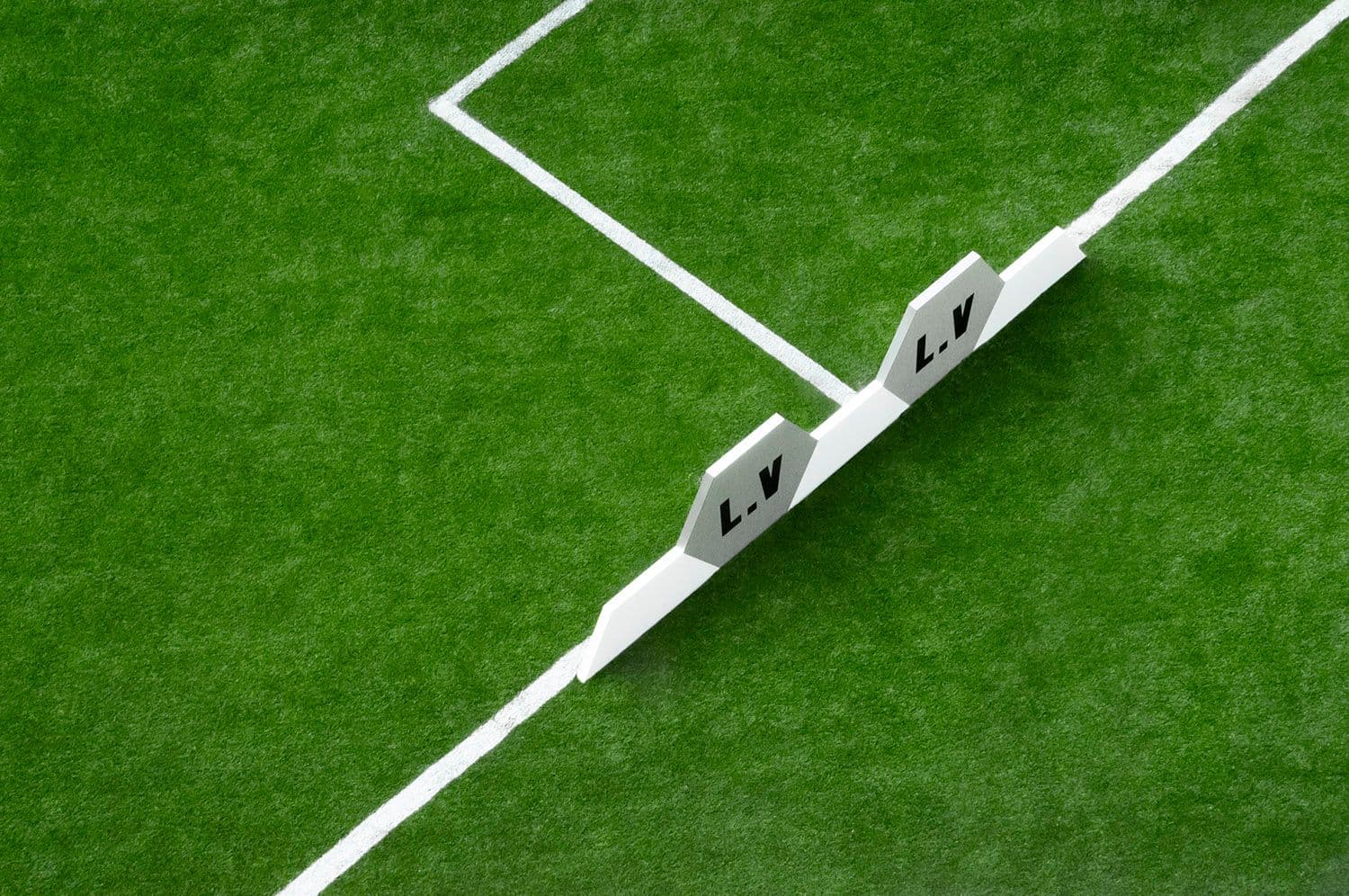 Two hexagonal LV corner flags positioned at a pitch line intersection.