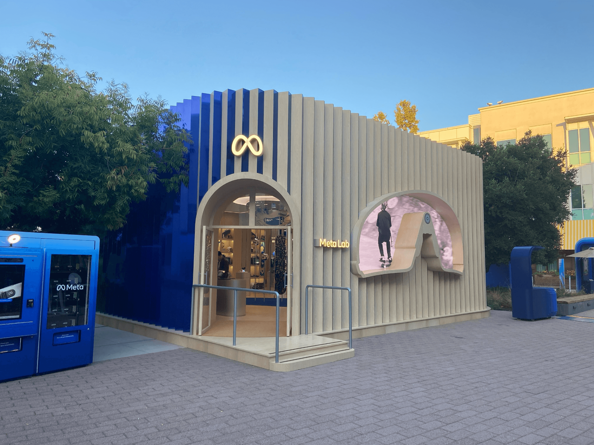 Exterior of the Meta Connect pavilion with an arched entrance and illuminated infinity logo.