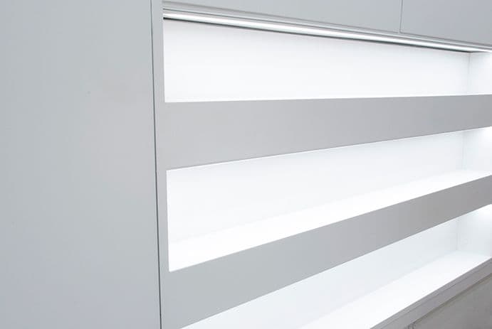 Close-up of angled white and gray shelf or counter edges.