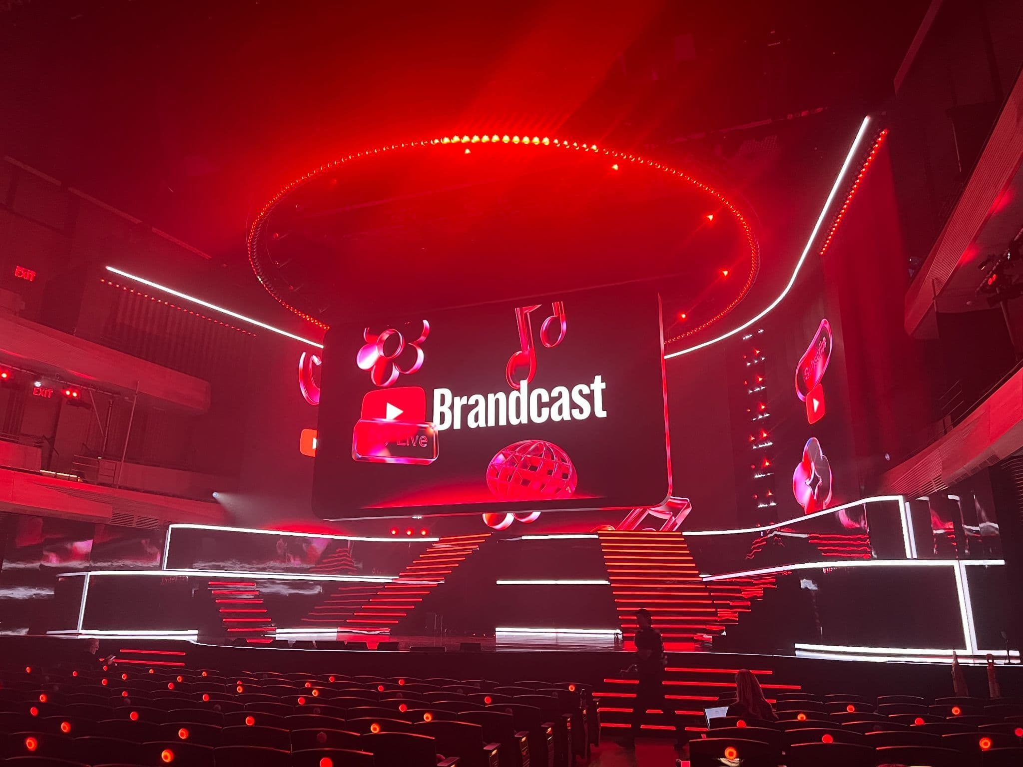 Circular stage screen displaying a game show set, ringed by blue lighting