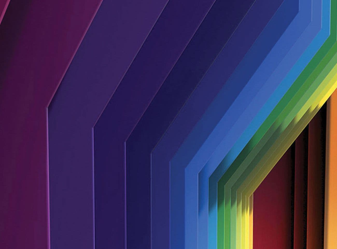 Close-up of an angled rainbow-gradient folded panel wall transitioning from purple to orange.