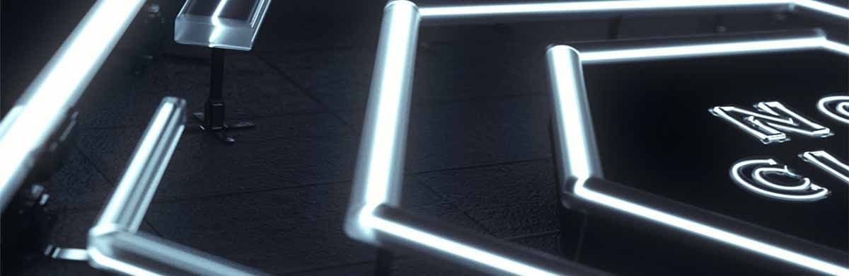 Neon light tubes arranged in geometric lines on a dark floor with partial text visible in the corner