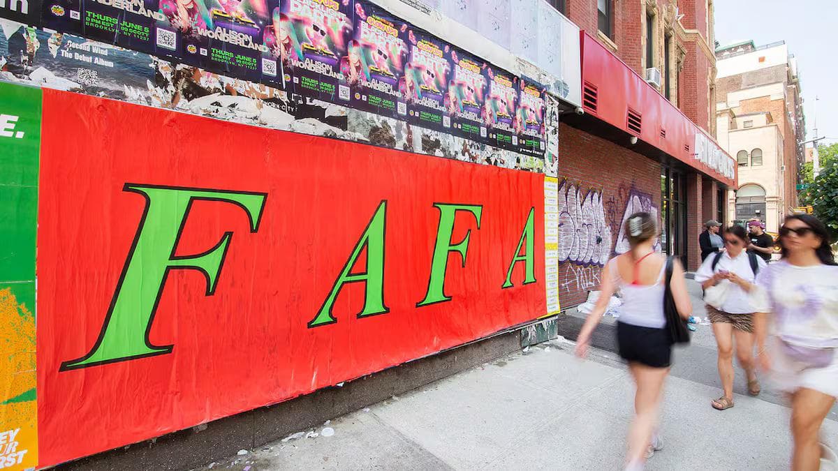 People walking past a Fa Fa guerilla poster