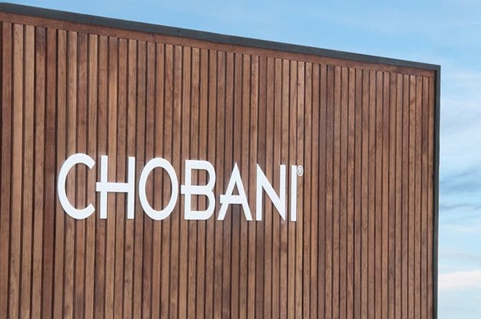 Close-up of the wood-slat exterior wall with the white CHOBANI wordmark.